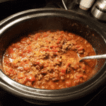 Brown ground beef in a skillet, Drain excess fat from beef, Add chopped onions and garlic to the skillet and sauté until translucent, Transfer beef mixture to crockpot, Add diced vegetables like bell peppers and carrots, Pour in tomato sauce or diced tomatoes, Add beef broth or water for desired consistency, Season with salt, pepper, and preferred spices, Stir in any beans or additional ingredients, Cover crockpot with lid, Set crockpot to low for 6-8 hours or high for 3-4 hours, Stir occasionally if possible, Taste and adjust seasonings if needed, Add any quick-cooking ingredients like pasta in the last 30 minutes, Garnish with fresh herbs before serving, Serve hot with desired sides